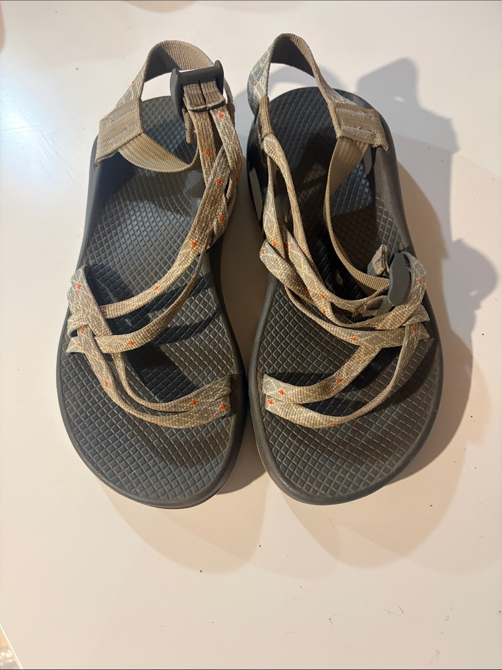 Chaco tan webbing sandals with black footbed and orange dots